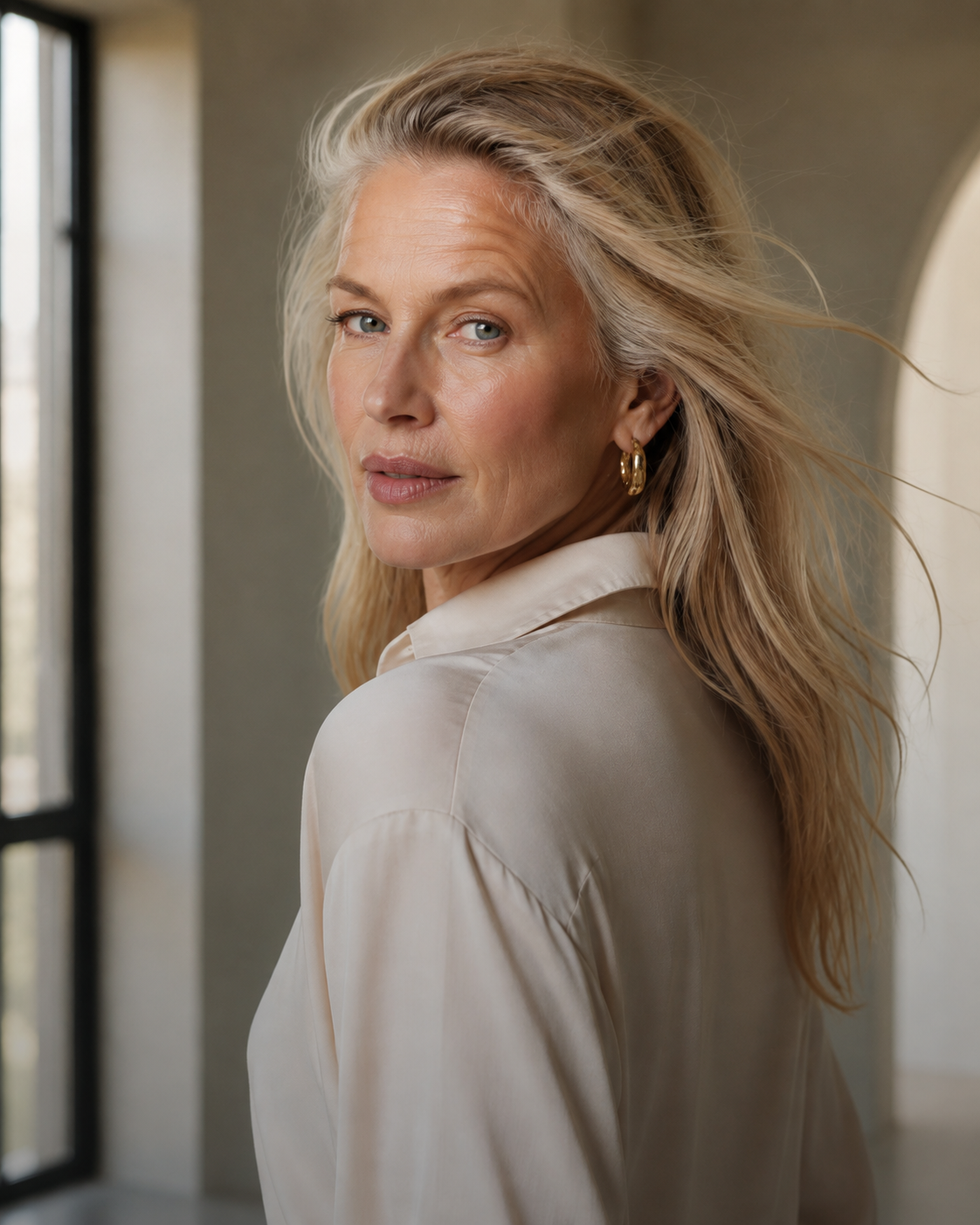 Mature blonde woman looking over shoulder in editorial light